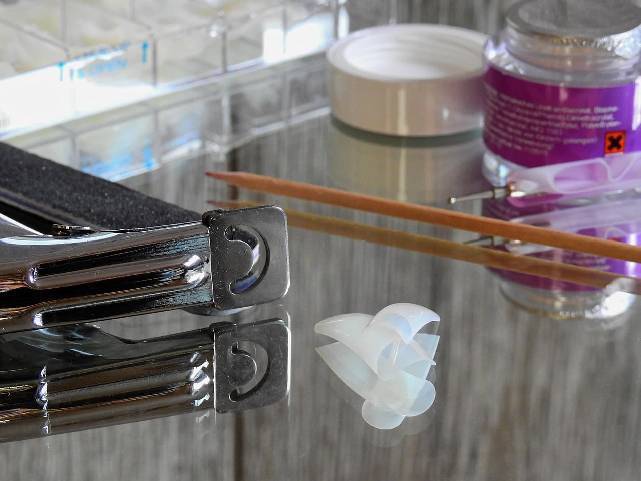 Nail tips and tools on a glass table