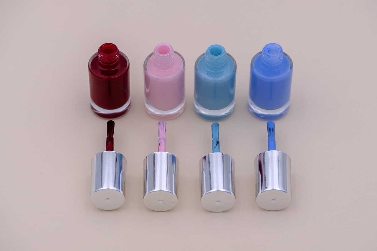 Four bottles of nail polish in a row