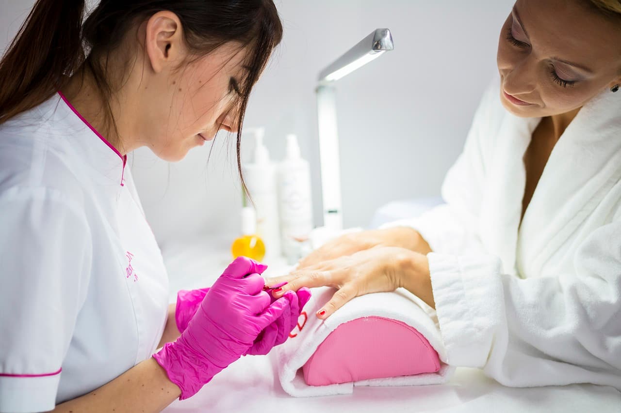A nail technician at work in a salon